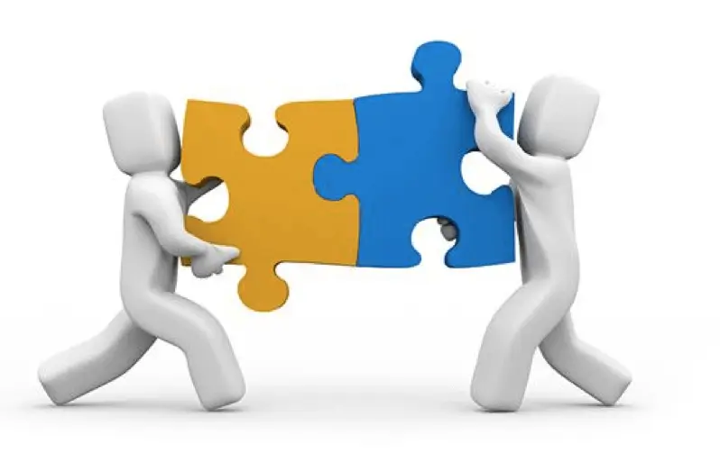 Intentional Approach to Mentorship. two white figurines holding two interlocked puzzle pieces that are yellow and blue