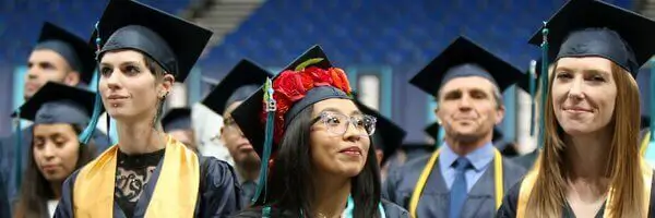 Photo of Portland Community College graduates in caps and gowns.