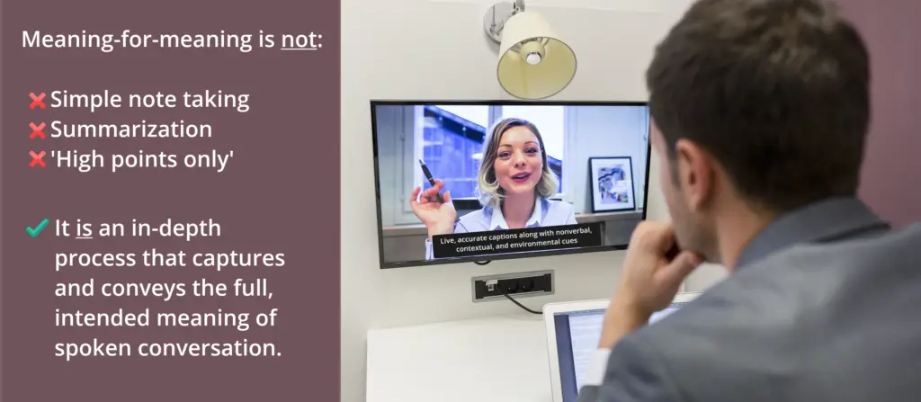 A man sits at a desk watching a video call on a wall-mounted screen. On the screen, a woman speaks with hand gestures, and live captions appear at the bottom: "Live, accurate captions along with nonverbal, contextual, and environmental cues." On the left side of the image, text explains that meaning-for-meaning transcription is not simple note taking, summarization, or 'high points only,' but an in-depth process that conveys full meaning.
